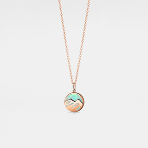 Necklace with a round pendant featuring a mountain design on a light gray background
