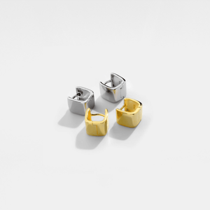Four square hoop earrings in gold and silver on a white background