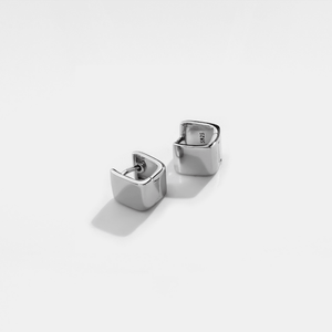 Silver square hoop earrings on a light gray background