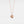 A rose gold-plated locket necklace with a star design on the locket, suspended from a delicate chain.