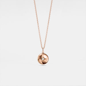 A rose gold-plated locket necklace with a star design on the locket, suspended from a delicate chain.