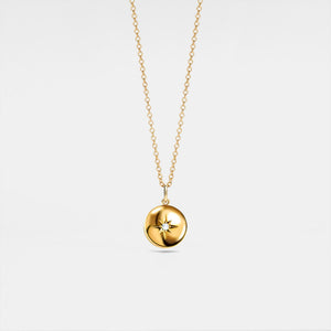 A gold-plated locket necklace with a star design on the locket, suspended from a delicate chain.