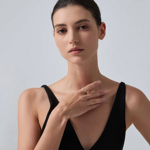 Woman wearing a black dress with a plain background