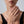 Close-up of a woman's hand wearing a ring with a neutral background