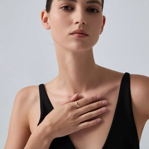 Woman wearing a black dress with a plain background