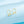 Gold earrings on a light blue background