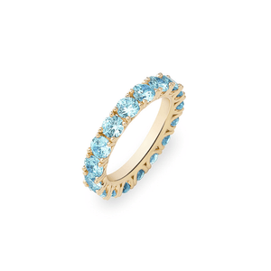 Gold ring with blue gemstones on a white background