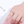 Rose gold ring with diamonds on a hand against a white background