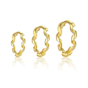 Set of gold hoop earrings on a white background