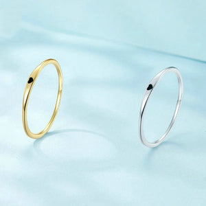 Gold and silver rings on a light blue background