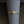Gold heart-shaped ring on a gray cylindrical stand with a blurred background