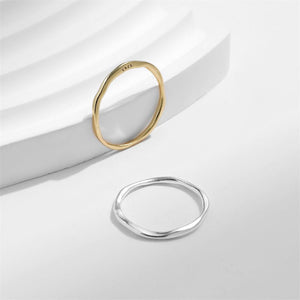 Gold and silver rings on a white surface