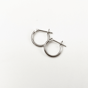 Pair of silver hoop earrings on a white background