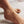 Gold anklet with a diamond on a foot.
