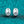 Silver earrings with gemstones on a teal textured background