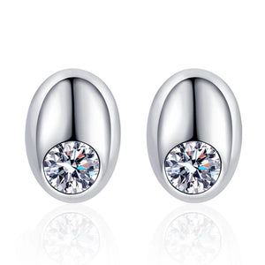 Silver earrings with clear gemstones on a white background