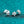 Silver stud earrings with a small gemstone on a teal glittery background