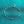Silver bracelet with small round charms on a teal background