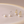 Pearl jewelry set with silver and gold earrings on a beige background
