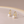 Gold earrings with pearl drops on a beige background