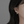 Pearl earring worn by a person with dark hair on a neutral background