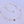Gold necklace with round pendants on a light purple background