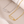 Two necklaces with safety pin designs, one gold and one silver, on a beige background.