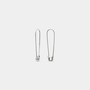 Pair of silver safety pins on a white background