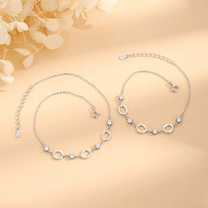 Silver bracelet with floral design on a beige background