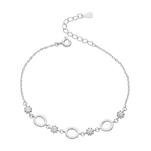 Silver bracelet with circular links and floral designs on a white background