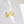 Gold hoop earrings on a white surface