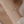 Pearl bracelet on a wrist against a soft beige background