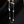 Pearl necklace with silver chain on a dark background