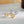 Gold and silver earrings on a light surface