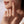 Close-up of a hand with a snake ring on a neutral background