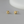 Pair of gold knot earrings on a gray background