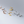 Set of gold and silver ear cuffs on a gray background