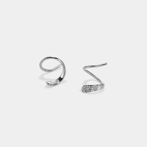 Pair of silver spiral earrings on a light gray background