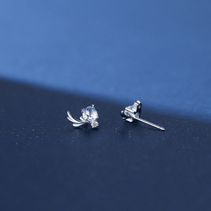Pair of silver earrings with gemstones on a blue background