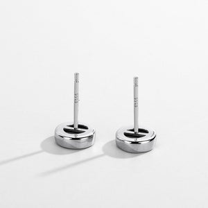 Pair of silver earrings on a white background