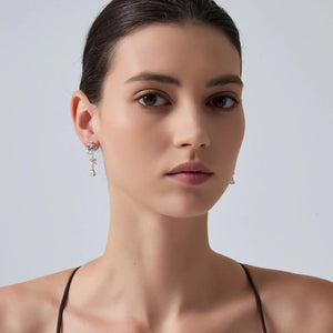 Woman wearing earrings with a plain background