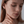 Model wearing a gold stud earring featuring starfish design
