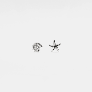 A pair of stud earrings featuring one conch shell and one starfish design, both in white gold plating, on a white background.