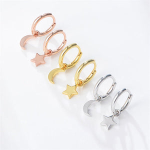 Three pairs of hoop earrings with star and moon charms in rose gold, gold, and silver on a white background.