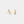 Gold earrings with musical note design on a light gray background