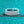 Silver ring with baguette-cut diamonds on a teal background