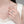 Close-up of a hand wearing a silver ring with a blurred background