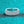 Silver ring with gemstones on a turquoise glittery background