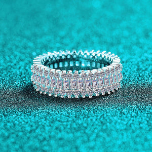 Silver ring with gemstones on a turquoise glittery background