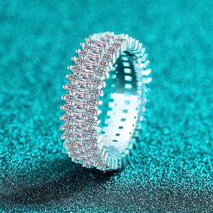 Silver ring with diamonds on a teal glittery background